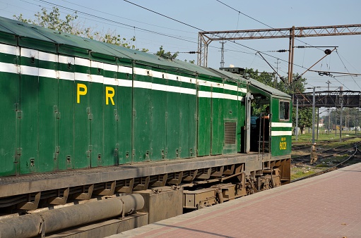 Lahore, Pakistan - September 28, 2012: A Pakistan Railways diesel electric engine with driver parked at Lahore's main railway station. The locomotive was attached to the Lahore - Karachi passenger train - the Business Express - run as a private-public partnership between state owned Pakistan Railways and a private sector group. Pakistan Railways has declared massive financial losses during the last few years and is running on government subsidies. 