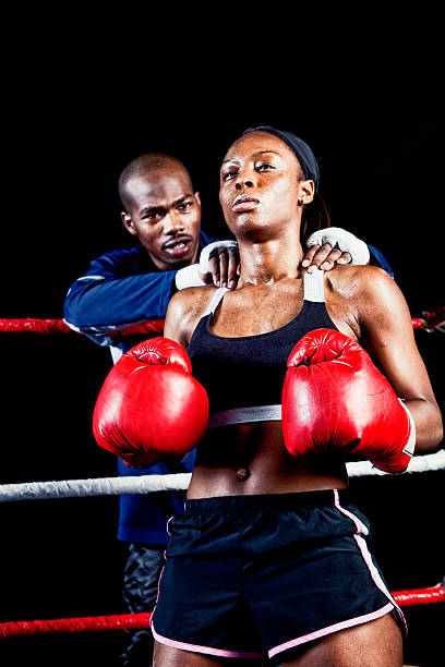 istock Female Boxer with Coach in the Ring 471563717