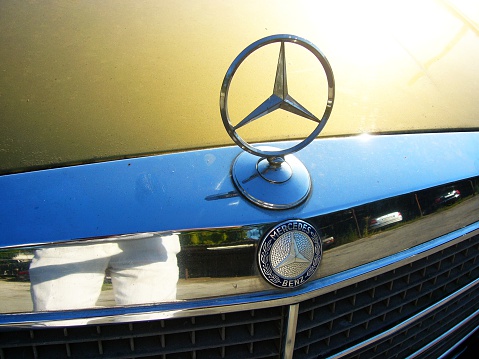 Moldova, Chisinau - July 26, 2012: A photo of Mercedes Benz sign on the hood grille of parked gold Mercedes Benz 350SE. The Mercedes-Benz W116 is a series of flagship vehicles produced from September 1972 through 1979. The W116 automobiles were the first Mercedes-Benz models to be officially called S-Class.