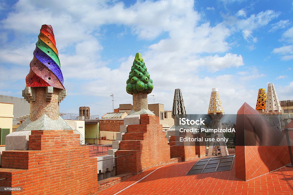 Roof of Palau Guell. Barcelona, Spain- May 12, 2013. The colorful mosaics chimneys made by broken ceramic tiles on the roof of Palau Guell. The palace is one of the earliest Gaudi's masterpiece. 12 May 2013. Barcelona, Spain  Palau Guell Stock Photo