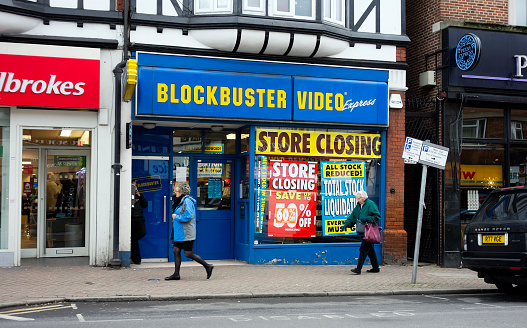 Beckenham, England - February 15, 2013: A branch of Blockbuster Video Express with numerous closing down posters. Blockbuster Video went into administration in January 2013 and many of its branches were closed, this branch in Beckenham, Kent (in the south east London suburbs) being one of them.