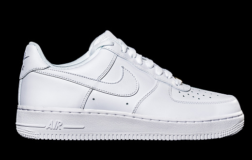 New York, USA - November 22, 2012: White Air Force 1 sneaker isolated on black background. The Nike Air Force, now known as the Air Force 1 (or AF1 or AF-1) athletic shoe is a product of Nike, Inc.