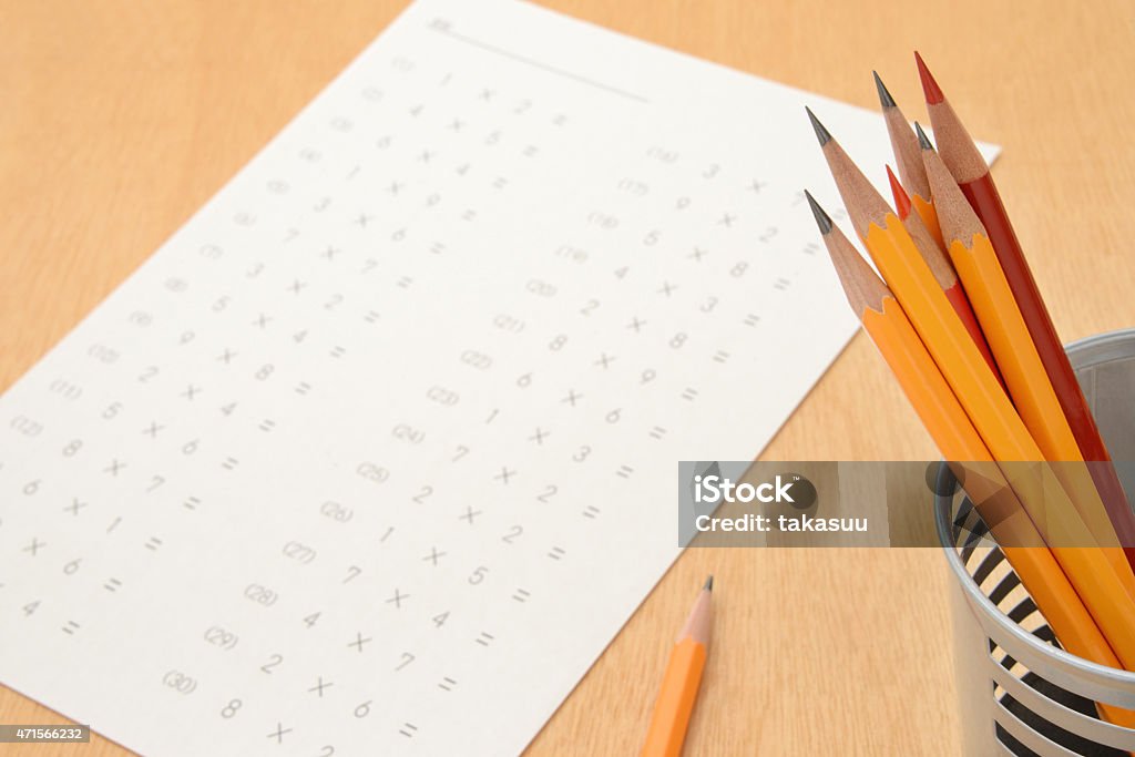 A sheet with multiplications on and a pot of pencils  School educaiton concepts, exam and pencils 2015 Stock Photo