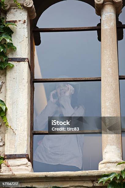 Woman On Mobile Through Old Window Stock Photo - Download Image Now - Adult, Building Exterior, Built Structure