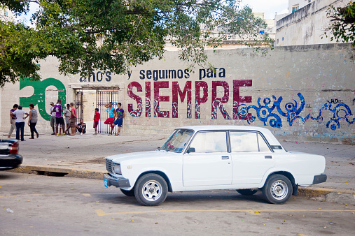 Havana, Cuba - February 23, 2010: Old Lada 2107 Russian car parked against public school. With an estimated 60,000 vintage cars still in Cuba, these old classics are a tribute to the nostalgia of the old days.