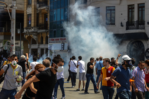 Istanbul, Turkey - June 11, 2013: protestors running for life during gas attack at mass protests on Taksim Square, Istanbul, Turkey