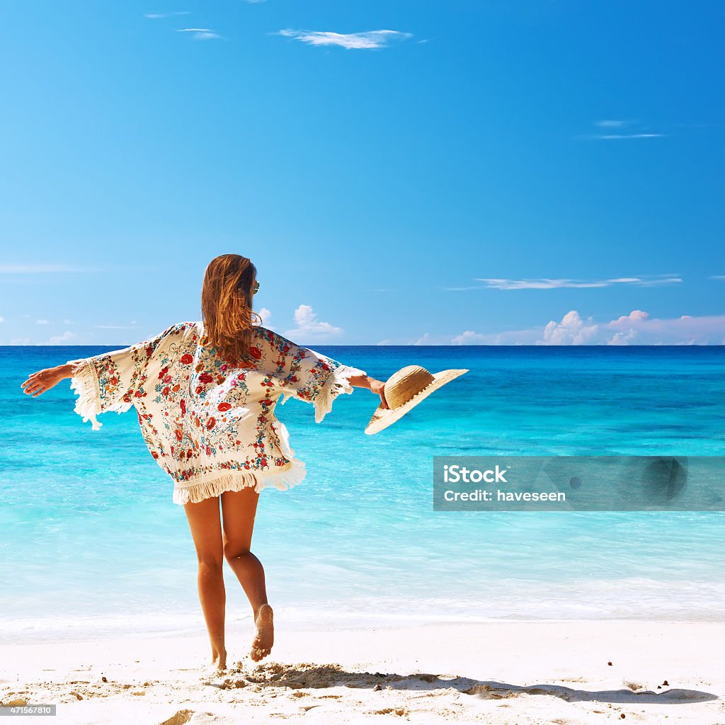 Woman with sarong on beach at Seychelles Woman with sarong on beach Anse Intendance at Seychelles, Mahe Sarong Stock Photo