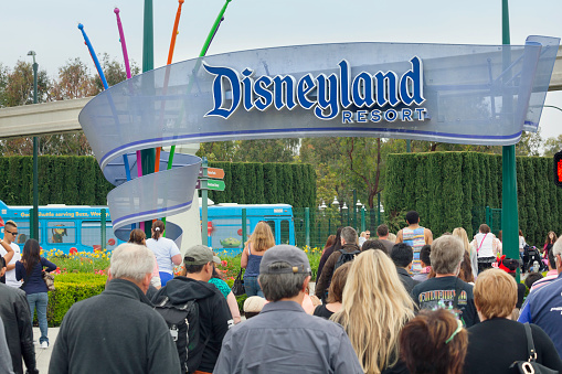Anaheim, California, USA - April 30, 2013: A large group of people entering the Disneyland Resort in Anaheim, where Disneyland Park and Disney California Adventure Park are located.