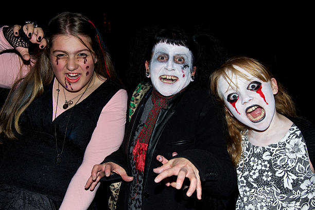 Cork, Ireland - October 31, 2012: A family dressed up in costumes for a Halloween Parade and posing like monsters.