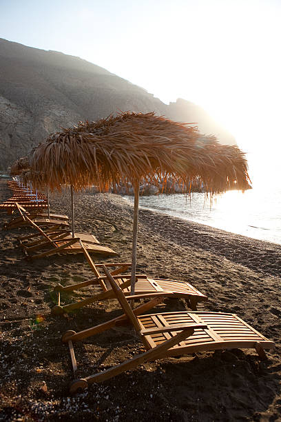 istock Sunbeds in Perissa, Santorini, Greece 471569733