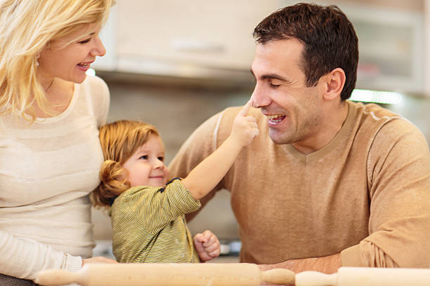 istock Happy family playing with flour in the kitchen. 471573228