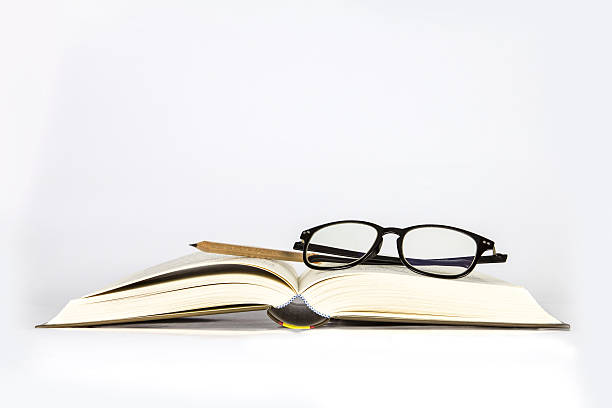 istock black rimmed glasses placed on opened book 471573504