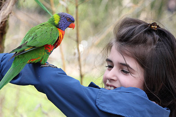 istock Girl and rainbow lorikeet 471573669