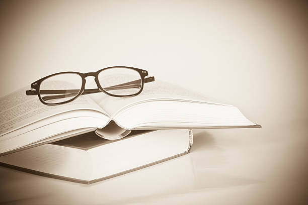 istock black rimmed glasses placed on opened book 471573818