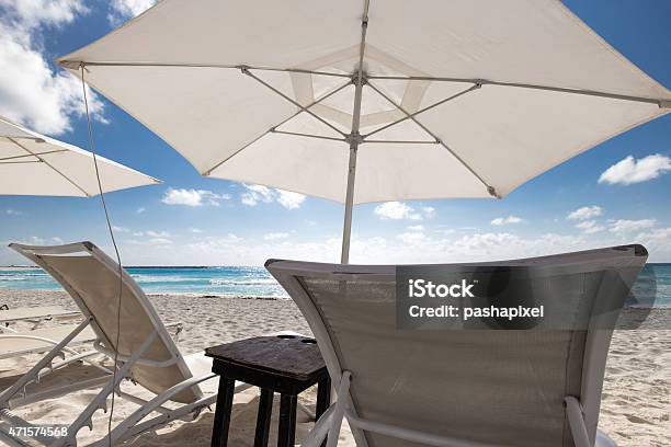 Beach With Sun Umbrellas And Beds Stock Photo - Download Image Now - 2015, Bahamas, Beach