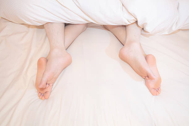 istock couple feet in the bed 471574728