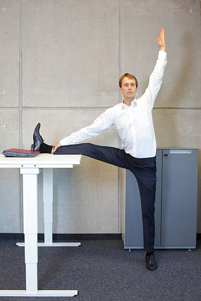 istock exercises in office. business man leg stretching 471574950