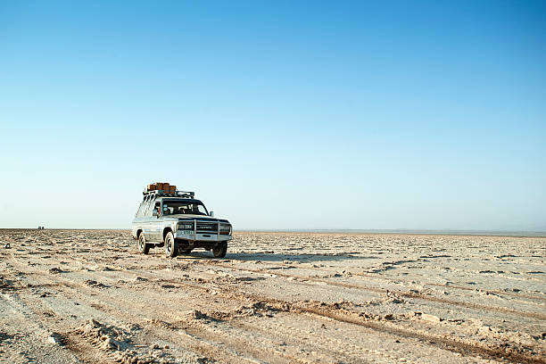 A FWD auto mobile leaves tracks (where it got stuck) in the Sahara Desert sand near Timbuktu in Mali