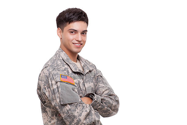 istock Smiling young soldier with arms crossed 471575597