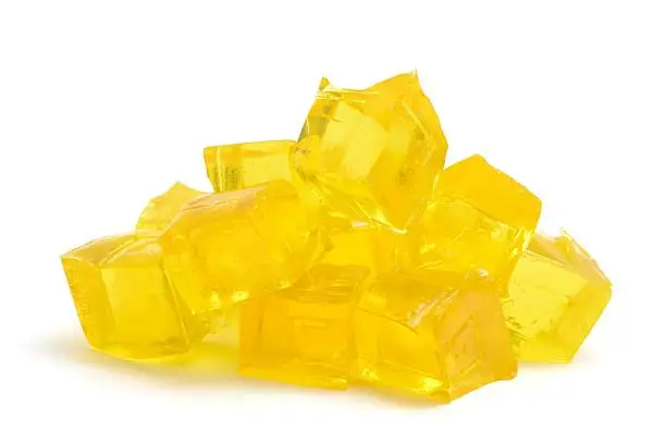 A heap of  concentrated Jelly cubes isolated on a white background.