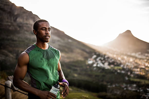istock Tired African American athlete looking positively after serious 471576268