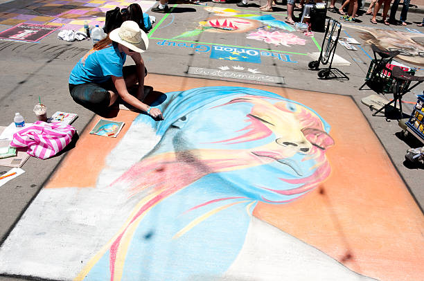 Denver, Colorado - June 2, 2013: An artist at work at the Denver chalk art festival a sunny day in Larimer square in downtown.