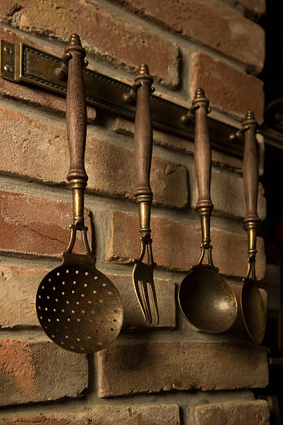 istock Antique kitchen utensils hanging on the wall 471576604