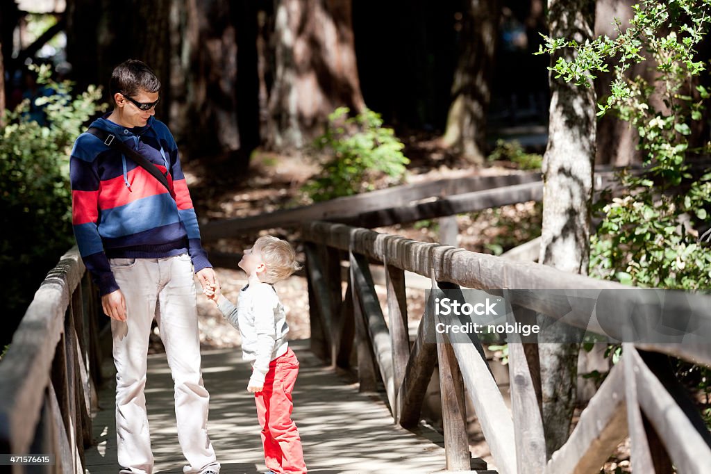 family of two hiking smiling happy father and his son hiking in redwood forest, caucasian family of two enjoying time together outdoors Child Stock Photo