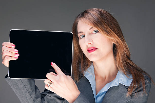 istock Business Woman Holding Electronic Tablet 471576638