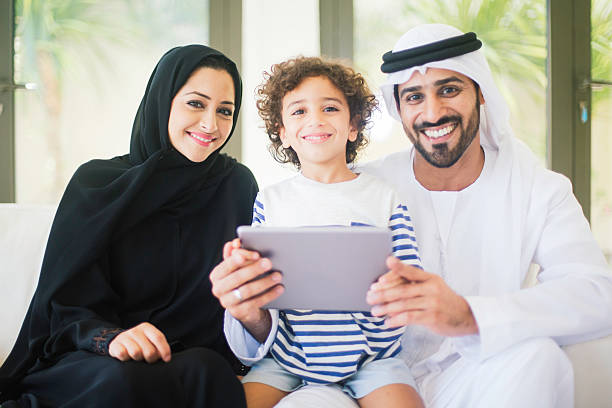 istock Middle eastern family posing at home with digital tablet. 471576644