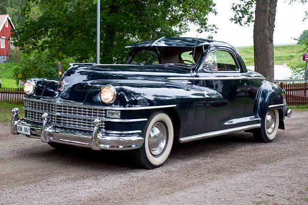 Uppsala, Sweden - July 05, 2011: Car enthusiast driving a fully restore  Crysler New Yorker 3PCPE from 1948, in a classic car cavalcade around the town Uppsala in Sweden.