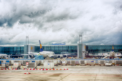 Frankfurt, Germany, June 9, 2013: Frankfurt Airport terminal exterior, passenger aircraft parked at arrivals