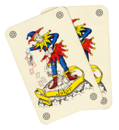 Paris, France - June 11, 2013: Two playing card joker, jester style on a globe.