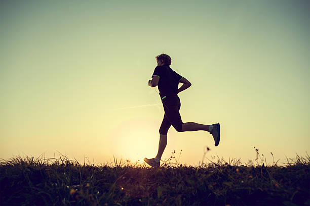 istock Running man silhouette in sunset time 471581078