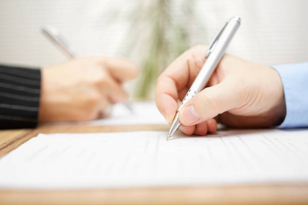 istock man and woman writing on document 471581102