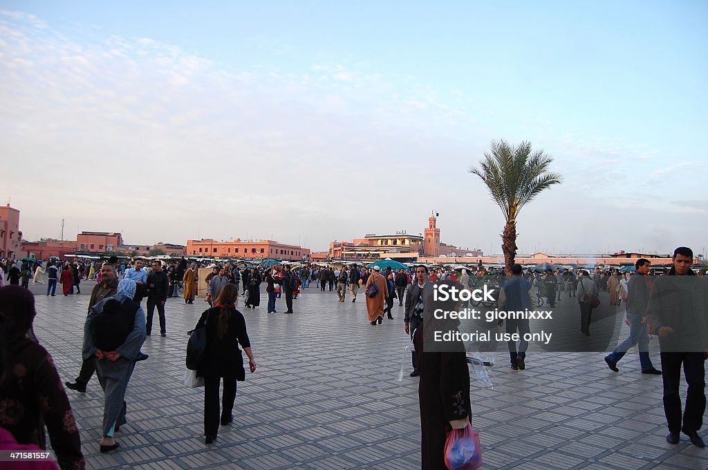 Jemaa El-Fnaa square, Marrakech - Morocco Marrakesh, Morocco - January 19, 2010: Jemaa El-Fnaa square at dusk, Marrakech. Locals and tourists walking in the famous large square, centre of city activity and trade. Africa Stock Photo