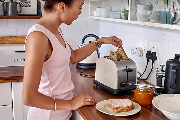 brinde mulher cozinha - toaster imagens e fotografias de stock