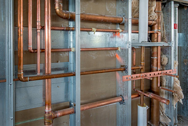 Copper Plumbing Rough-in with Steel Stud Construction Rough-in for a commercial restroom in an office building. copper wall stock pictures, royalty-free photos & images