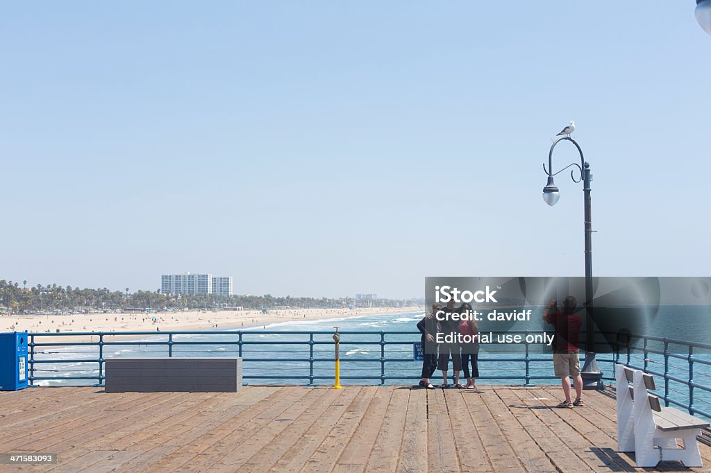 Family Taking Vacation Photos Santa Monica, California, USA - May 11, 2013: Family group taking portrait photos on the Santa Monica Pier California Stock Photo