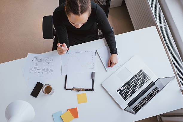 istock Businesswoman analyzing financial data at a white desk 471583106
