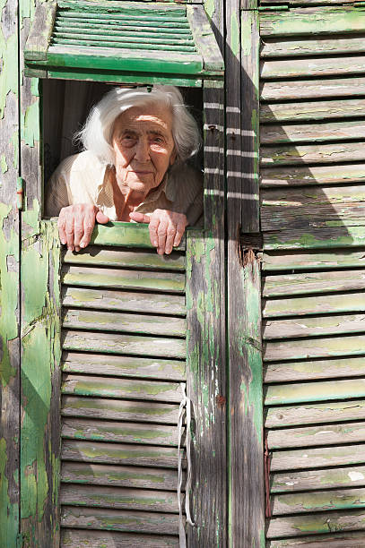 istock Senior Woman at window 471584167