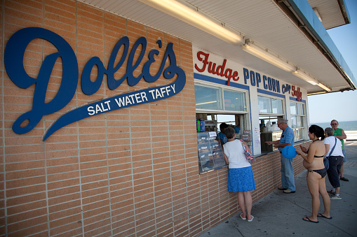 Rehoboth Beach, Delaware, USA - May 31, 2013.  Tourists and beach goers line up to buy salt water taffy and other sweets from Dolle's, which is located on the boardwalk.