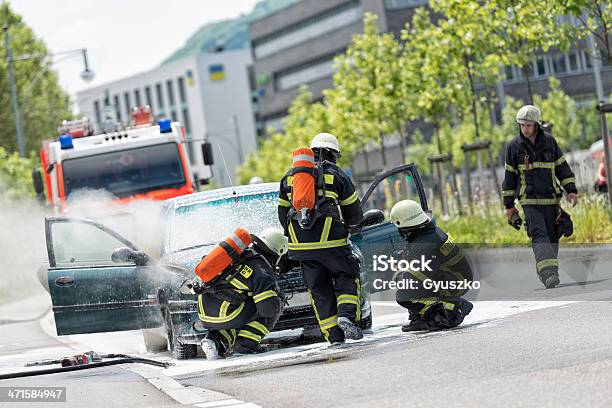 Burning Fahrzeug Gestellt Von Feuerwehrleuten In Schützende Kleidung Stockfoto und mehr Bilder von Auto