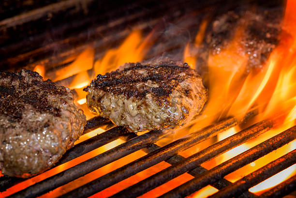 istock Hamburgers on a Flaming Grill 471587575