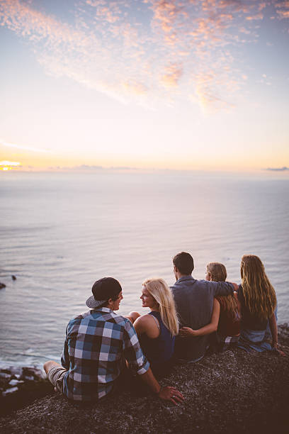 istock Group of teens watching the sunset over the sea 471587612