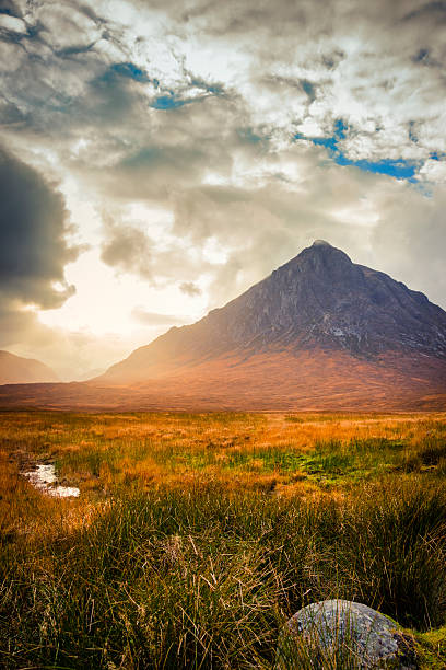 Sunset in Glen Etive Looking from Rannoch Moor to Stob Dearg and Buachaille Etive Mor at the head of Glencoe with the evening sun streaming out of Glen Etive. buachaille etive mor photos stock pictures, royalty-free photos & images