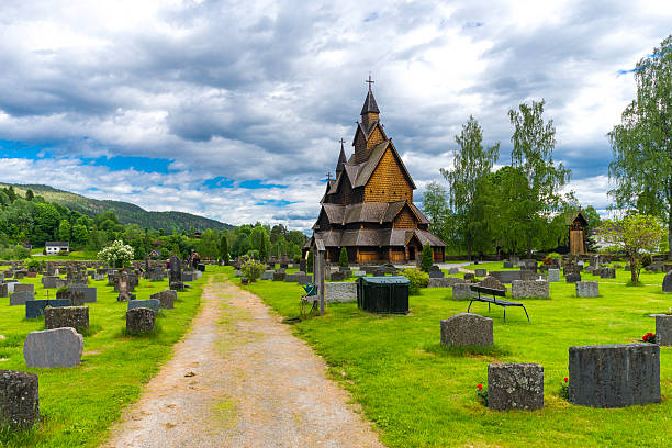 Heddal Stave Church in Norway A horizantal shot of Heddal stave church with his cementary. heddal stock pictures, royalty-free photos & images