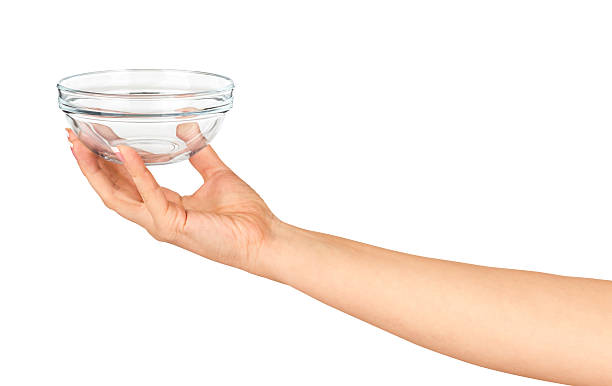 istock Hand holding an empty glass salad bowl 471590782