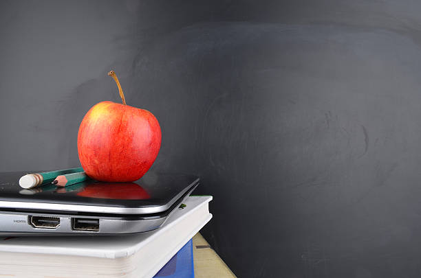 istock Learning and education concept with books, apple and blackboard 471591538
