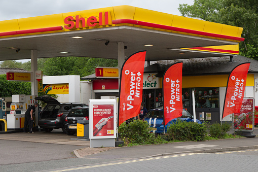 Newport, Shropshire, England, UK - June 22nd 2013 - Drivers filling their cars with petrol at Shell petrol garage in town.